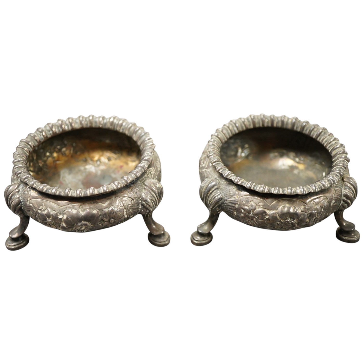 A pair of Victorian embossed silver bun salts, by Elkington & Co, Birmingham, 1852/3, top diameter 65mm, 7.7oz.